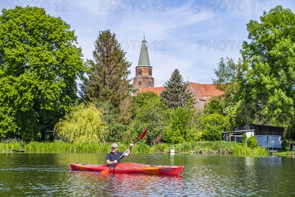 Paddler in a kayak in front of the Cathedral of St. Peter and Paul, Cathedral Island, Brandenburg an der Havel, Brandenburg, Germany, Europe