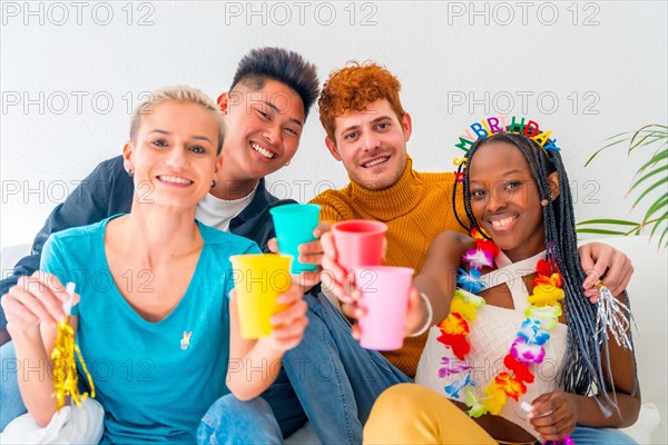 Lgtb couples of gay boys and girls lesbian in a portrait on a sofa at a house party, birthday party, toasting with colored glasses