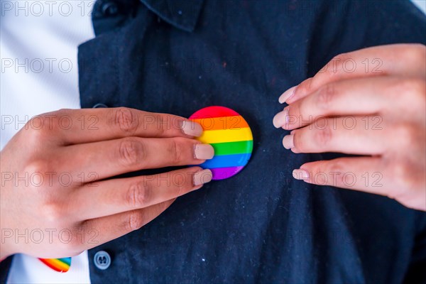 Man with rainbow reusable bag and lgbt badge, pride month