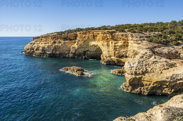 Beautiful cliffs and rock formations by the Atlantic Ocean at Marinha Beach in Algarve, Portugal, Europe