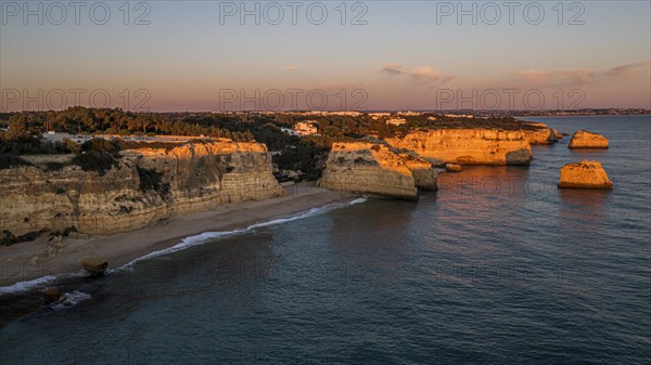 Sunset at Praia da Marinha, rocks and cliffs, steep coast in the Algarve, Portugal, Europe