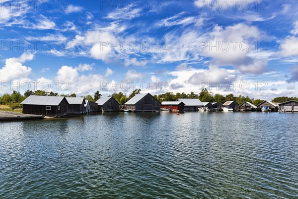 Boathouses in the harbour, Kaeringsund fishing village, backlight, Fasta Aland, Aland Islands, Aland Islands, Finland, Europe