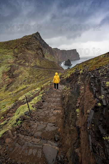 Hiker, coastal landscape, cliffs and sea, rugged coast with rock formations, Cape Ponta de Sao Lourenco, Madeira, Portugal, Europe