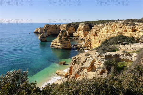 Beautiful cliffs and rock formations by the Atlantic Ocean at Marinha Beach in Algarve, Portugal, Europe