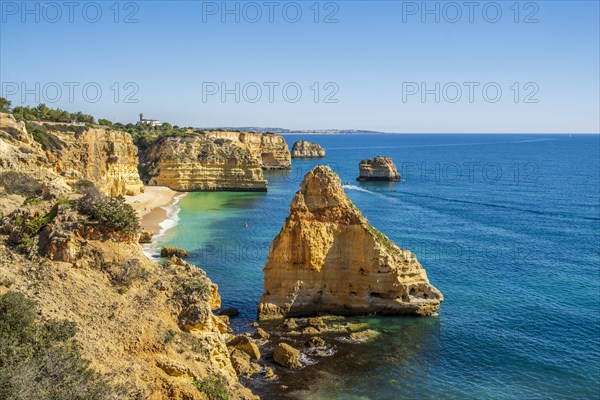 Beautiful cliffs and rock formations by the Atlantic Ocean at Marinha Beach in Algarve, Portugal, Europe