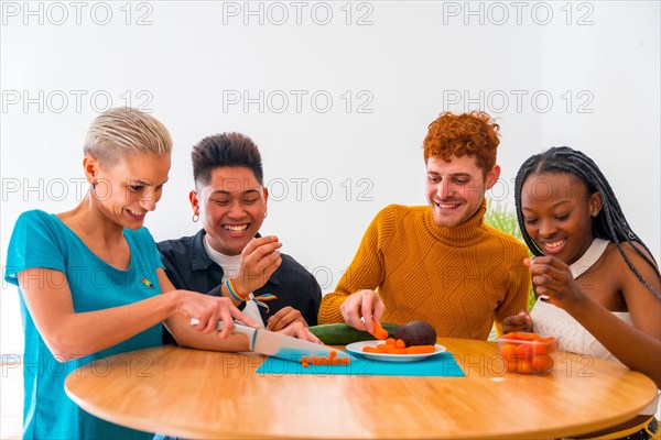 Group of friends preparing vegetarian food. They prepare food and have fun in the kitchen