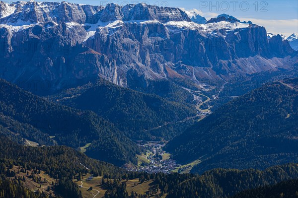 The tourist town of Selva Gardena, view from the Seceda peak, in the background the snow-covered peaks of the Sella massif, Val Gardena, Dolomites, South Tyrol, Italy, Europe