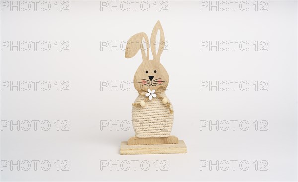 Easter composition. Wooden bunny. White background. Studio