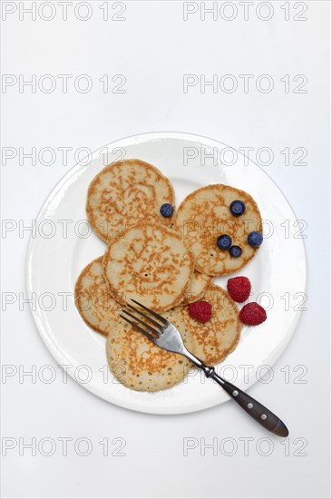 Blini, blinis on plate with fruit, mini pancakes