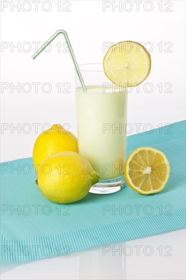 Drinking yoghurt lemon, lemon shake in a glass with lemons
