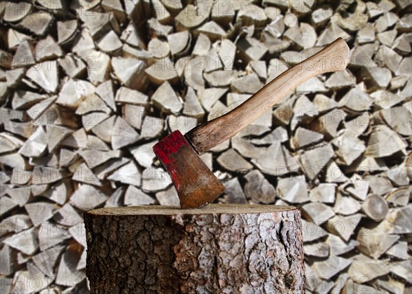 Axe on chopping block in front of wooden bend, Black Forest, Baden-Wuerttemberg, Composing, Germany, Europe