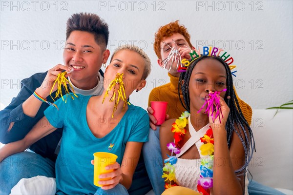 Lgtb couples of gay boys and girls lesbian in a portrait on a sofa at a house party, at a birthday party