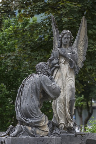 Sculptures on an old tomb, cemetery of Riezlern in Kleinwalsertal, Austria, Europe