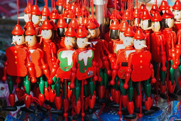 Set of wooden pinocchio dolls with his long nose on a white background