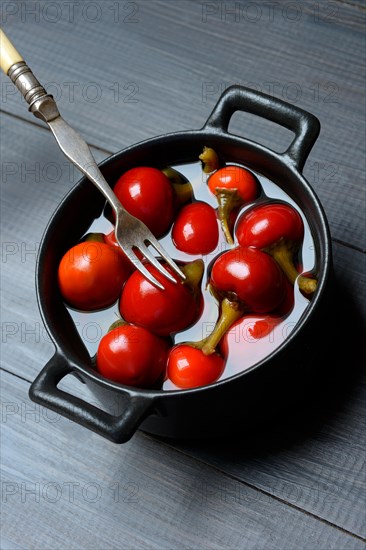 Potted cherry peppers in vinegar, chilli, paprika