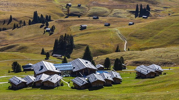 Wellness Resort, Adler Mountain Lodge and autumnal alpine meadows and huts on the Alpe di Siusi, Val Gardena, Dolomites, South Tyrol, Italy, Europe