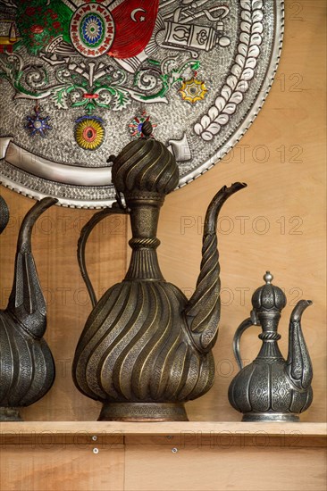 Ancient metal jug in oriental style in antique market