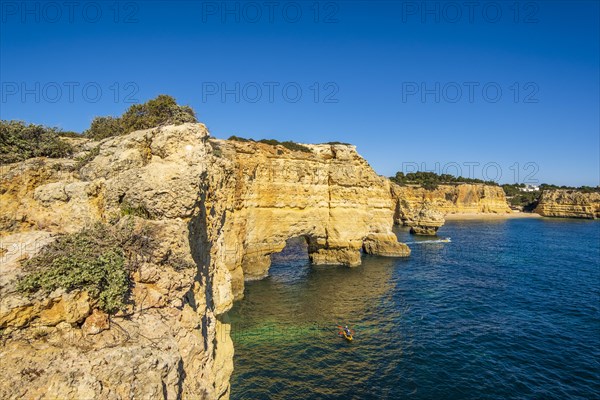 Beautiful cliffs and rock formations by the Atlantic Ocean at Marinha Beach in Algarve, Portugal, Europe