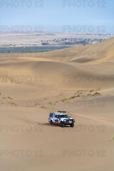 Off-road vehicle in sand dunes above the Orange River, also Oranjemund, Sperrgebiet National Park, also Tsau ÇKhaeb National Park, Namibia, Africa