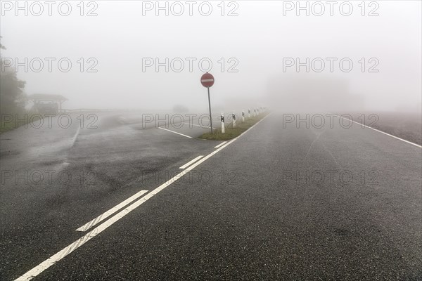 Empty car park at Koeterberghaus on mountain top, dreary autumn weather with fog, Koeterberg, Luegde, Weserbergland, North Rhine-Westphalia, Germany, Europe