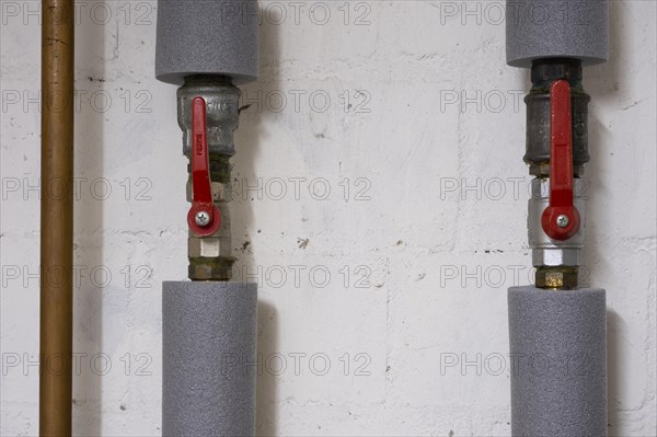 Insulated piping with shut-off valve, next to it a copper pipe, North Rhine-Westphalia, Germany, Europe