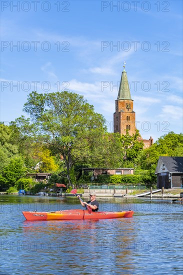 Paddler in a kayak in front of the Cathedral of St. Peter and Paul, Cathedral Island, Brandenburg an der Havel, Brandenburg, Germany, Europe