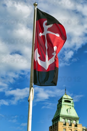 Flag with anchor against a slightly cloudy sky, harbour, Stockholm, Sweden, Europe