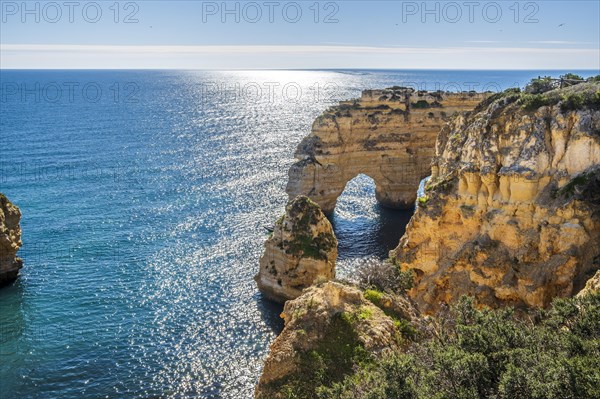 Beautiful cliffs and rock formations by the Atlantic Ocean at Marinha Beach in Algarve, Portugal, Europe