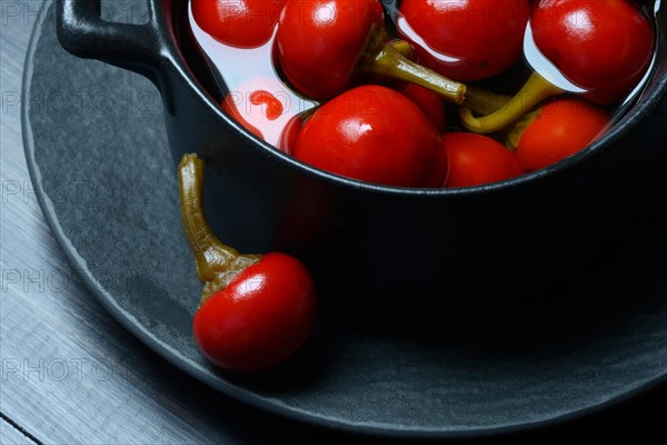 Potted cherry peppers in vinegar, chilli, paprika