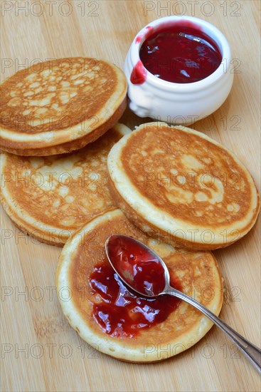 Pancake with raspberry jam and spoon