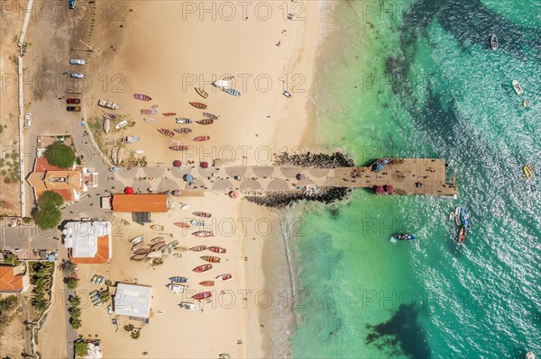 Pier and boats on turquoise water in city of Santa Maria, island of Sal, Cape Verde, Africa