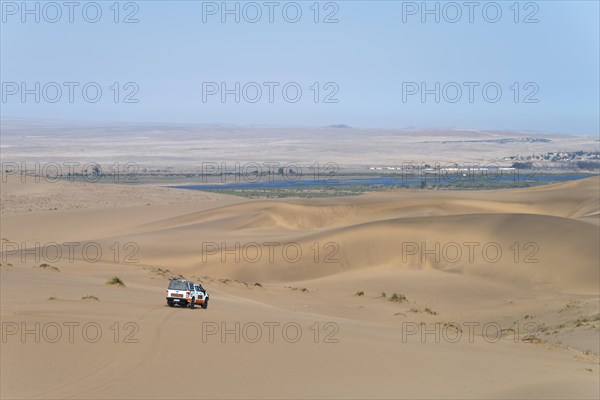 Off-road vehicle in sand dunes above the Orange River, also Oranjemund, Sperrgebiet National Park, also Tsau ÇKhaeb National Park, Namibia, Africa