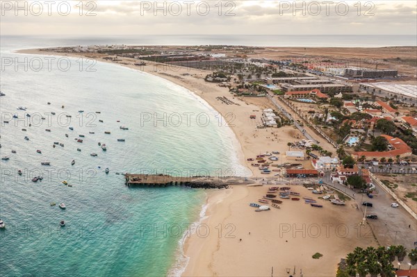 Pier and boats on turquoise water in city of Santa Maria, island of Sal, Cape Verde, Africa