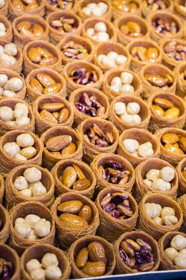 Nut stuffed dessert of mini size cuisine in hand