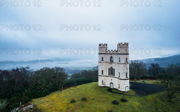 Misty morning over Haldon Belvedere from a drone, Lawrence Castle, Higher Ashton, Exeter, Devon, England, United Kingdom, Europe