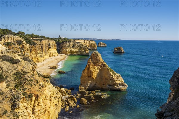 Beautiful cliffs and rock formations by the Atlantic Ocean at Marinha Beach in Algarve, Portugal, Europe