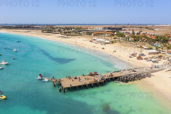 Pier and boats on turquoise water in city of Santa Maria, island of Sal, Cape Verde, Africa