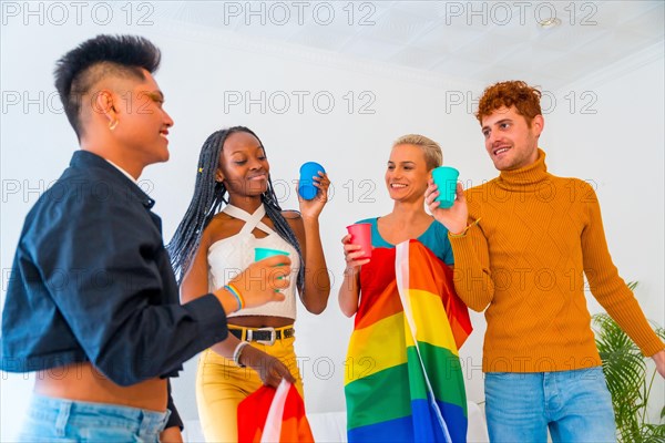 LGBT pride, lgbt rainbow flag, group of friends dancing and toasting with glasses in a house at party