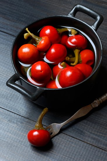 Potted cherry peppers in vinegar, chilli, paprika