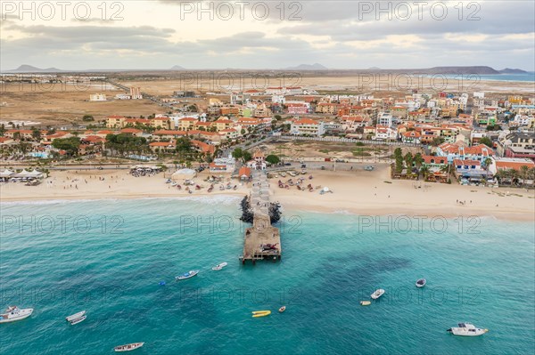 Pier and boats on turquoise water in city of Santa Maria, island of Sal, Cape Verde, Africa