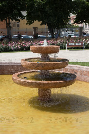 Water gushing off the fountain in the rose garden