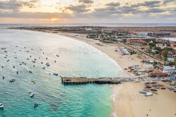 Pier and boats on turquoise water in city of Santa Maria, island of Sal, Cape Verde, Africa