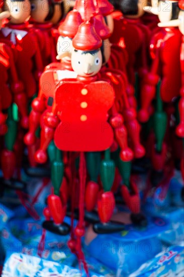 Set of wooden pinocchio dolls with his long nose on a white background