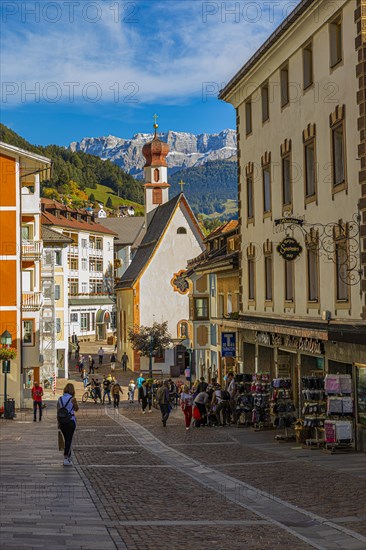 Pedestrian zone in the tourist town of Sankt Ulrich, Antonius Chapel in the back, Val Gardena, Dolomites, South Tyrol, Italy, Europe