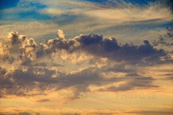 Dramatic colorful cloudy sky with picturesque clouds lit by sunset