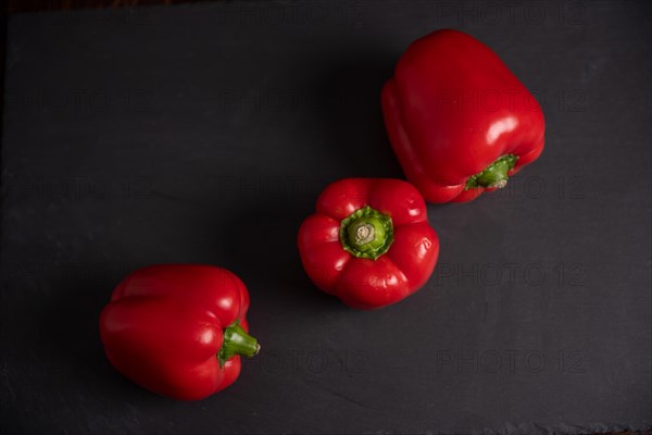 Red peppers on slate, fitness, cooking, vegetarian, vegan, vitamins, growing, healthy, close up, three, kitchen