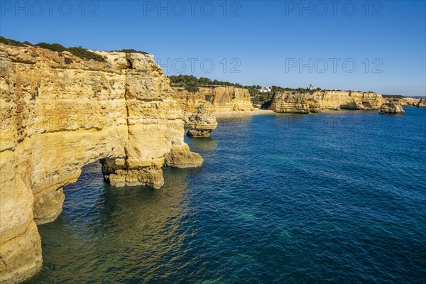 Beautiful cliffs and rock formations by the Atlantic Ocean at Marinha Beach in Algarve, Portugal, Europe