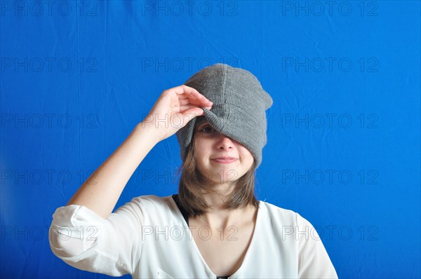 Teen hiding his face with his bonnet