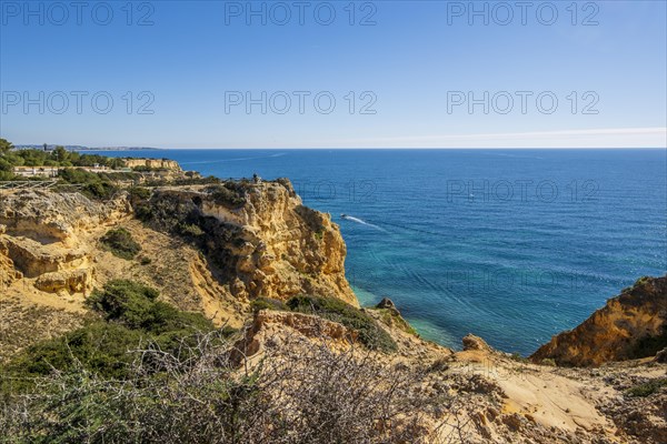 Beautiful cliffs and rock formations by the Atlantic Ocean at Marinha Beach in Algarve, Portugal, Europe