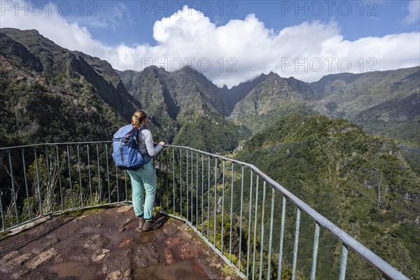 Hiker at the Miradouro dos Balcoes viewpoint, Ribeira da Metade mountain valley and the central mountains, Madeira, Portugal, Europe